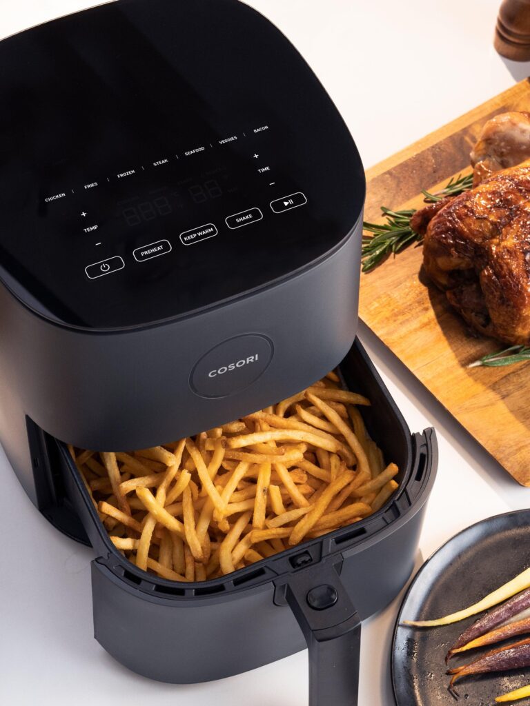 Cosori air fryer with golden crispy fries prepared using less oil